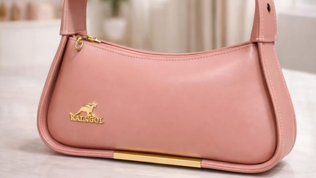 Pink handbag with a brand logo on a light surface