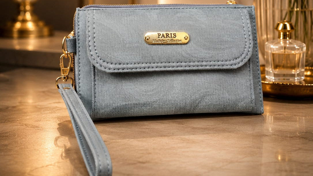 Blue wallet with a gold 'PARIS' tag on a wooden surface