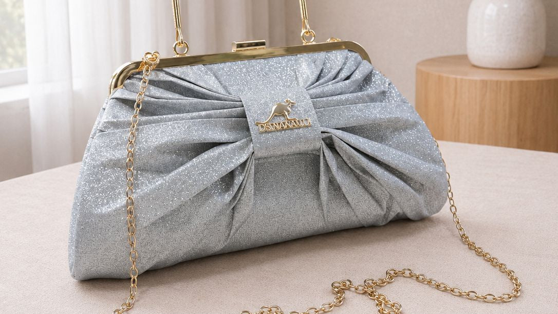 Blue handbag with a bow on a table with a neutral background