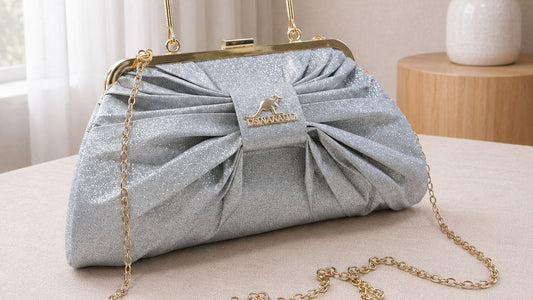 Blue handbag with a bow on a table with a neutral background