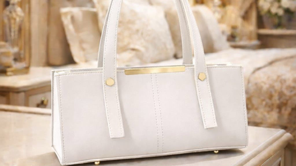 White handbag on a table with a luxurious room background