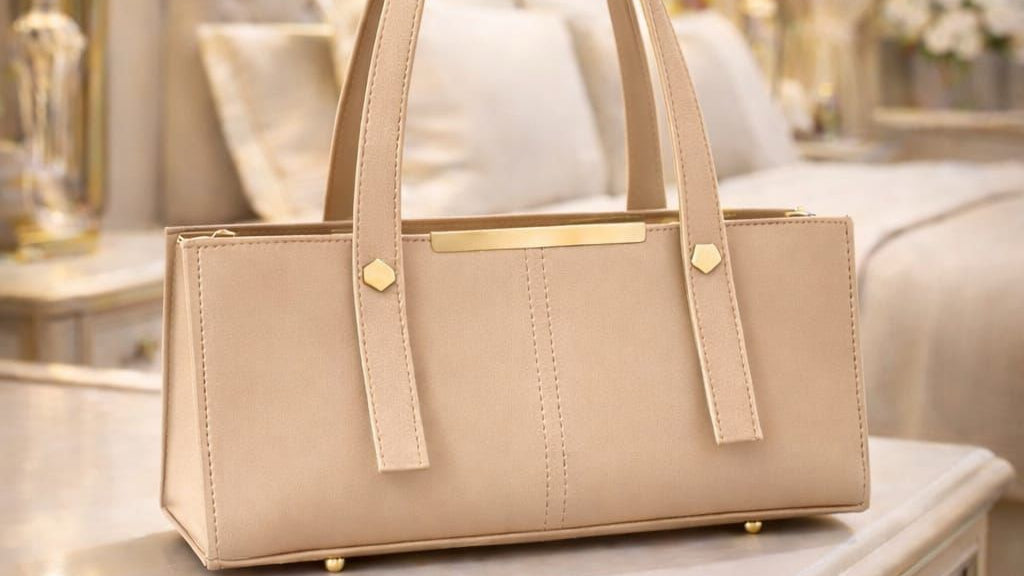 Beige handbag on a table with a blurred background