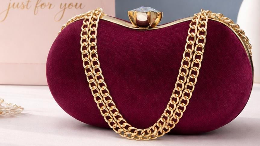 Red clutch bag with gold chain and 'Just For You' text in the corner